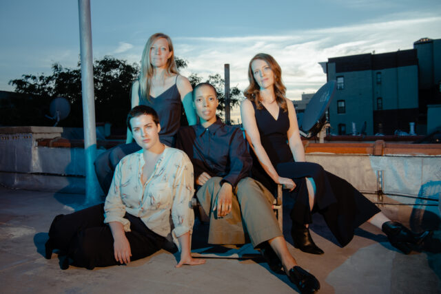 Portrait of the four member of the Overlook String Quartet. Each member is seated.