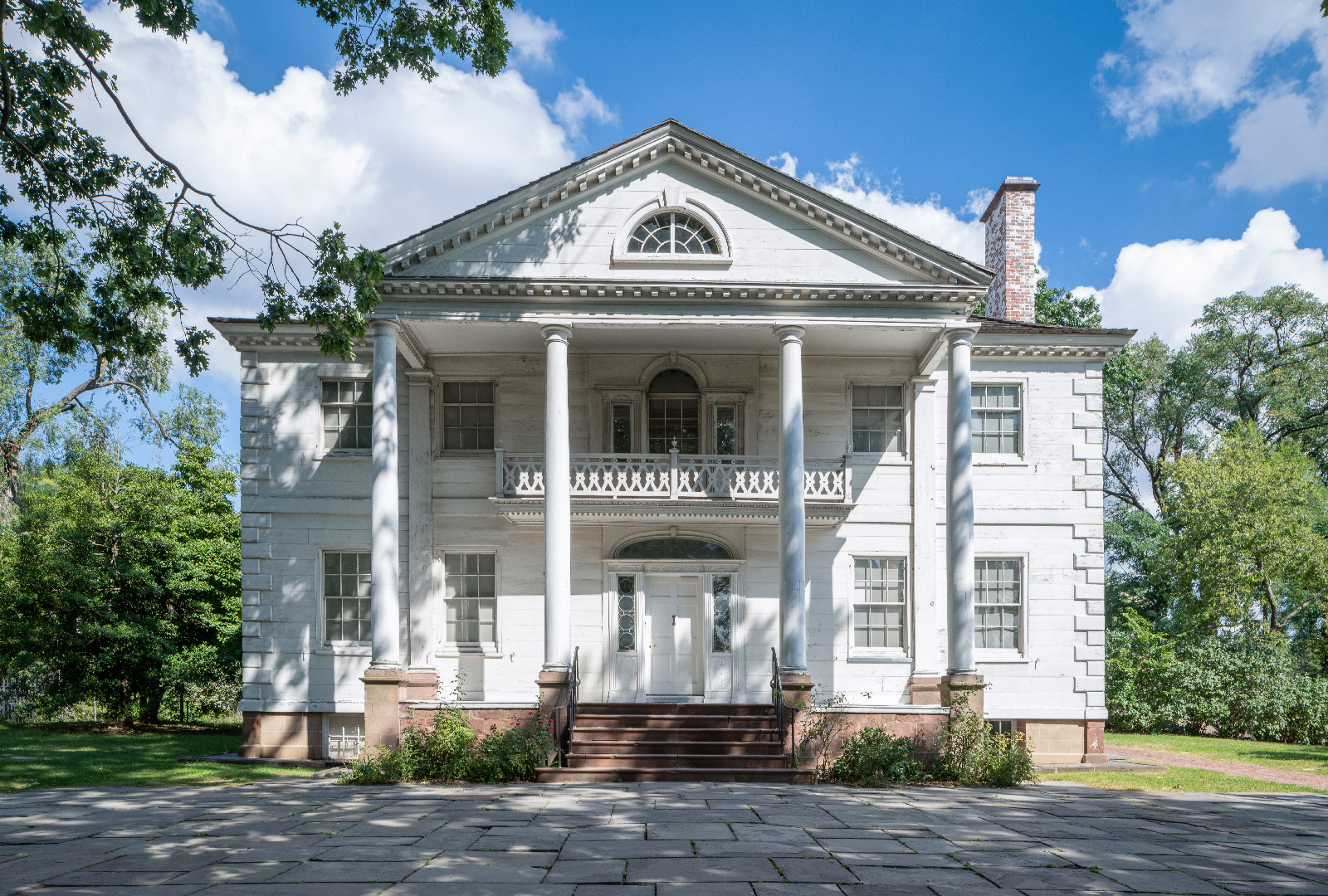 Fotografía de la fachada exterior de la Mansión Morris-Jumel en un día soleado